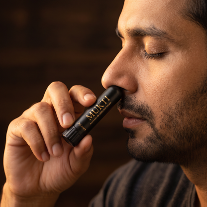 Man using MUKTI nasal inhaler to control cravings